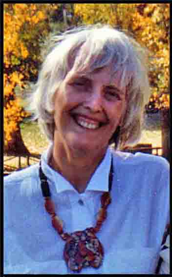 picture shows Jean-Robert Bayard with grey hair smiling broadly, wearing a necklace with a large tiger.